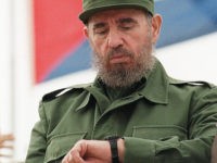 (FILES) Cuban President Fidel Castro checks his watch while watching the traditional Labor Day parade attended by thousands of people in Havana's Plaza of the Revolution, May 1, 1998. Castro resigned on February 19, 2008 as president and commander in chief of Cuba in a message published in the online version of the official daily Granma.       AFP PHOTO/Adalberto ROQUE (Photo credit should read ADALBERTO ROQUE/AFP/Getty Images)