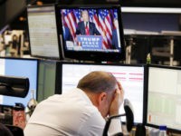 A broker reacts as new elected US President Donald Trump shows up on a television screen at the stock market in Frankfurt, Germany, Wednesday, Nov. 9, 2016.(AP Photo/Michael Probst)