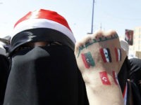 (An anti-government protester displays paintings on her hand of other countries involved in the Arab Spring revolutions during a rally to demand the ouster of Yemen's President Ali Abdullah Saleh in Sanaa October 26, 2011. The words read, "Go out." REUTERS/Louafi Larbi )