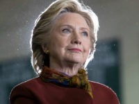 Democratic presidential candidate Hillary Clinton listens as vice presidential candidate Sen. Tim Kaine, D-Va. speaks during a campaign event at the Taylor Allderdice High School, Saturday, Oct. 22, 2016, in Pittsburgh, Pa. (AP Photo/Mary Altaffer)