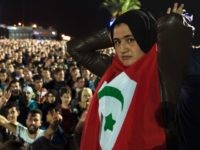 A protester holds the flag of the Rif Republic as protesters shout slogans in the northern city of Al Hoceima on October 30, 2016, following the death of fishmonger Mouhcine Fikri, who was crushed to death on October 28 in a rubbish truck in Al Hoceima, as he reportedly tried to protest against a municipal worker seizing and destroying his wares. Thousands of Moroccans on October 30 attended the funeral of the fishmonger whose gruesome death in a rubbish truck crusher has caused outrage across the North African country. An image of his inert body -- head and arm sticking out from under the lorry's crushing mechanism -- went viral on social media, sparking calls for protests nationwide including in the capital Rabat. / AFP / FADEL SENNA (Photo credit should read FADEL SENNA/AFP/Getty Images)