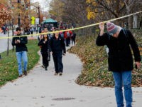 Ohio State students duck under police tape after a shelter-in-place notification was lifted following an attack Monday, Nov. 28, 2016, at Ohio State University in Columbus, Ohio. (Joshua A. Bickel/The Columbus Dispatch via AP)