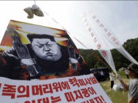 FILE - In this Thursday, Sept. 15, 2016, file photo, North Korean defectors prepare to release balloons carrying leaflets and a banner denouncing North Korean leader Kim Jong Un for North Korea's latest nuclear test, in Paju, near the border with North Korea, South Korea. Out of the limelight, and sometimes in secret, a small corps of former U.S. diplomats and intelligence officials, often working with academic specialists, meet regularly with high-ranking North Koreans. They discuss everything from the details of North Korea's nuclear program to the concerns on the effects of international trade sanctions on Pyongyang. (AP Photo/Ahn Young-joon, File)