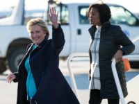 Democratic presidential nominee Hillary Clinton (L) arrives at Cleveland Burke Lakefront Airport November 6, 2016 in Cleveland, Ohio