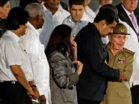 Cuba's President Raul Castro embraces Venezuela's President Nicolas Maduro waves as he arrives to a rally honoring his deceased brother Fidel Castro at the Revolution Plaza in Havana, Cuba, Tuesday, Nov. 29, 2016. Schools and government offices were closed Tuesday for a second day of homage to Fidel Castro, with the day ending in a rally on the wide plaza where the Cuban leader delivered fiery speeches to mammoth crowds in the years after he seized power. Fidel Castro passed away Friday Nov. 25. He was 90. At left Bolivia's President Evo Morales. Third from right Venezuela's First Lady Cilia Flores.(AP Photo/Ricardo Mazalan)