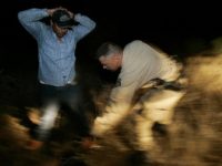 ** ADVANCE FOR WEEKEND EDITIONS, JULY 23-24 **A Border Patrol agent who asked not to be identified searches an illegal immigrant on the Tohono O'odham Nation in Arizona on June 9, 2005. The reservation is part of the Border Patrol's Tucson Sector__the busiest place in the country for illegal border crossings. (AP Photo/Laura Rauch)
