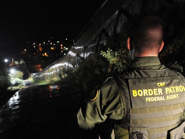 US Border Patrol agent Richard Funke patrols along the border fence between Arizona and Mexico at the town of Nogales on July 28, 2010. A federal judge blocked the most controversial parts of Arizona's new immigration law, barring police from checking the immigrant status of suspected criminals. The ruling came hours before the new law had been due to go into effect, handing temporary victory to civil rights groups and the Obama administration which has challenged the legislation. For the first time in the United States -- a nation built on generations of immigrants -- the law would make illegal immigration a crime and penalize anybody helping or giving work to undocumented workers. AFP PHOTO/Mark RALSTON (Photo credit should read MARK RALSTON/AFP/Getty Images)