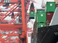 container is unloaded from an international freighter at a port in Tokyo on June 20, 2016. For May, Japan logged a deficit of 40.72 billion yen ($389 million), compared with a trade surplus of 823.18 billion yen in April, as exports of steel and semiconductors declined, the finance ministry said. / AFP / TOSHIFUMI KITAMURA (Photo credit should read