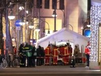 Security and rescue workers tend to the scene after a lorry truck ploughed through a Christmas market on December 19, 2016 in Berlin, Germany. At least two people have died as police investigate the attack and whether it is linked to a terrorist plot.