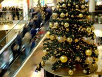 Shoppers on an escaltor pass by a Christmas tree on a Special Shopping Sunday in the Stadtgalerie in Hameln, Germany, 27 December 2015. Photo: Peter Steffen/dpa Peter Steffen / DPA