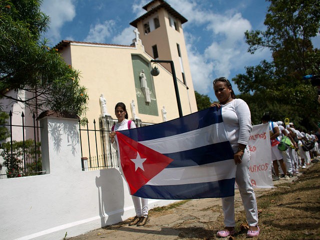 Ladies in White, a women's dissident group that calls for the release of political prisoners, begin their weekly march in Havana, Cuba, Sunday, March 20, 2016. U.S. President Barack Obama arrives Sunday afternoon for a three-day visit to Cuba, the first visit by a U.S. president to the island in nearly 90 years. (AP Photo/Rebecca Blackwell)