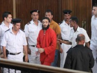 CAIRO, EGYPT - SEPTEMBER 29: Defendant Adel Habara enters the hearing room as he escorted by security forces during his trial on September 29, 2015 at Police Academy in Cairo, Egypt. Defendant Adel Habara and 35 others were accused of terrorism-related charges after 25 Egyptian security personnel were killed in the case known as the second Rafah massacre in Rafah in 2013. (Photo by Stringer/Anadolu Agency/Getty Images)