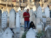 ALEPPO, SYRIA - JULY 06 : Muslims visit their relatives tombs at martyrdom after they performed Eid al-Fitr mass prayer during the Eid al-Fitr holiday in Atarib District of Aleppo, Syria on July 06, 2016. Eid al-Fitr is a religious holiday celebrated by Muslims around the world that marks the end of Ramadan, Islamic holy month of fasting. (Photo by Ahmed Hasan Ubeyd/Anadolu Agency/Getty Images)