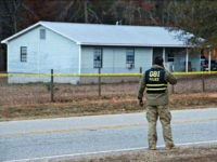 Georgia Bureau of Investigation Special Agent in Charge J.T. Ricketson works at a scene of a shooting involving multiple officers while serving a search warrant at a home in Crawford County, Ga., Monday, Dec. 12, 2016. Authorities said the suspect in the shooting at the home has died. (Woody Marshall/The Macon Telegraph via AP)