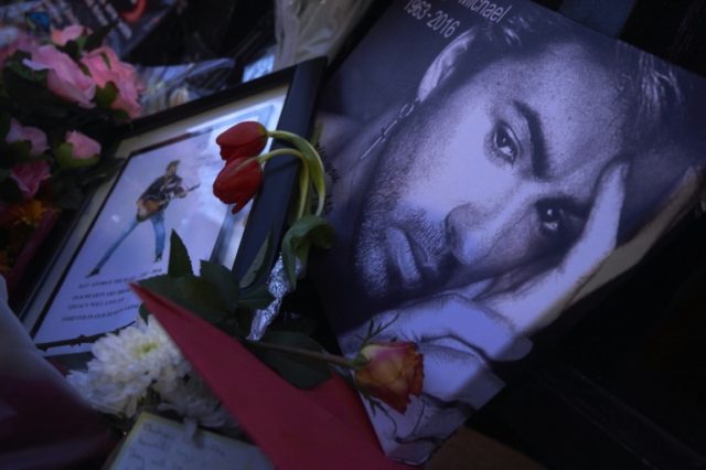 A well-wisher leaves a portrait of George Michael at a makeshift memorial outside the singer's home in north London, on December 27, 2016