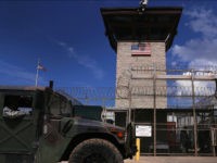 GUANTANAMO BAY, CUBA - OCTOBER 23:(EDITORS NOTE: Image has been reviewed by the U.S. Military prior to transmission.) A humvee passes the guard tower guard tower at the entrance of the U.S. prison at Guantanamo Bay, also known as 'Gitmo' on October 23, 2016 at the U.S. Naval Station at Guantanamo Bay, Cuba. The U.S. military's Joint Task Force Guantanamo is still holding 60 detainees at the prison, down from a previous total of 780. In 2008 President Obama issued an executive order to close the prison, which has failed because of political opposition in the U.S. (Photo by John Moore/Getty Images)