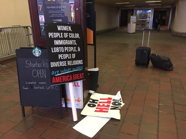 Protest signs at Union Station (Joel Pollak / Breitbart News)