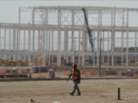 A man walks past a nearly deserted construction site Wednesday in Villa de Reyes, San Luis Potosi, Mexico, as workers shut down operations and remove equipment from the site of a canceled $1.6 billion Ford plant. Ford's cancellation, which costs the region thousands of projected jobs, has sounded alarms in Mexico and sent its currency tumbling. Rebecca Blackwell/AP