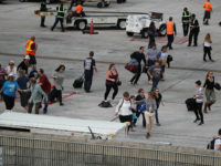 FORT LAUDERDALE, FL - JANUARY 06: People seek cover on the tarmac of Fort Lauderdale-Hollywood International airport after a shooting took place near the baggage claim on January 6, 2017 in Fort Lauderdale, Florida. Officials are reporting that five people were killed and eight wounded in an attack by a single gunman. (Photo by Joe Raedle/Getty Images)
