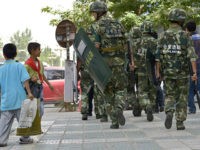 Chinese paramilitary policemen patrol a street in Kashgar city, northwest Chinas Xinjiang Uygur Autonomous Region, 23 July 2014. Chinese police shot dead dozens of knife-wielding attackers on Monday (28 July 2014) morning after they staged assaults on two towns in the western region of Xinjiang, the official Xinhua news agency said on Tuesday. A gang armed with knives had first attacked a police station and government offices in the town of Elixku, in Shache county, it said, quoting local police. Some moved on to the nearby town of Huangdi, attacking civilians and smashing and setting fire to six vehicles. An initial investigation showed that it was an organized and premeditated terrorist attack, Xinhua said. The dead and injured include not just Uighurs but members of Chinas majority Han Chinese population, the report said. The attack took place at the end of the holy month of Ramadan in Shache, also known by its Uighur name of Yarkant, located in Xinjiangs heavily Uighur southwestern part, close to the borders of Tajikistan, Pakistan and Afghanistan.(Imaginechina via AP Images)