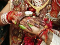 Bride Kalpana, 22, and her groom Bhavin Munjpara, 26, lying in a bed, exchange wedding vows inside a hospital in Ahmedabad February 17, 2012. The couple took their wedding vows in a hospital after Munjpara fractured his feet in a road accident on February 11, their relatives said. REUTERS/Amit Dave