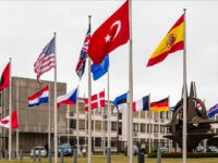 NATO country flags wave outside NATO headquarters in Brussels on Tuesday July 28, 2015. For just the fifth time in its 66-year history, NATO ambassadors met in emergency session Tuesday to gauge the threat the Islamic State extremist group poses to Turkey, and the debated actions Turkish authorities are taking in response. (AP Photo/Geert Vanden Wijngaert)
