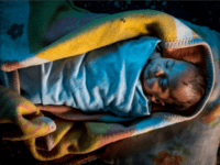 new baby A Syrian refugee baby is seen sleeping inside amakes bread at a tent camp on the outskirts of Izmir on April 28, 2016 in Izmir, Turkey. For many Syrian refugees, living in Turkey has become their only option. With the new E.U.-Turkey deal effectively shutting down the route to Europe …