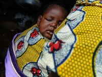 IJEBU-ODE, NIGERIA - NOVEMBER 06: 06: A Nigerian woman carries her baby in the town of Ijebu-Ode on November 6, 2009 in Ijebu-Ode, Nigeria. (Photo by Jamie McDonald - FIFA/FIFA via Getty Images)