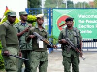 Zambian police officers stand guard outside the Presidential Election results centre, Mulungushi International Conference Centre, in Lusaka on January 21, 2015. Zambian police fired teargas to disperse around 100 supporters of the leading opposition candidate in Zambia's presidential elections on January 21 as they waited for results of the vote. Some 21,00 voters in dozens of polling stations were expected to cast ballots on January 21, after presidential elections were extended for a second day, in a hotly contested presidential election to replace Michael Sata, who died in office last year. AFP PHOTO / SALIM DAWOOD / AFP / Dawood SALIM (Photo credit should read DAWOOD SALIM/AFP/Getty Images)