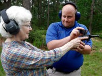 In this April 30, 2016 photograph, Jake Driskell, a Laurel police officer and owner of Gun Guy Tactical, helps Crestview Baptist Church member and first time shooter Katherine Huffman, line up her sights with her husband's revolver during the live fire portion of a enhanced concealed carry class sponsored by the church for members and area residents in Petal, Miss. The 20 participants received hands on assistance during a practical shooting exercise, a thorough review on the fundamentals of safe handling of firearms in addition to a review of the basic and enhanced Mississippi Concealed Carry laws. (AP Photo/Rogelio V. Solis)