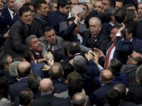 Ruling Justice and Development Party and main opposition Republican People's Party legislators scuffle in Turkey's parliament during deliberations over a controversial package of constitutional amendments that would greatly expand President Recep Tayyip Erdogan's powers, in Ankara, Turkey, Wednesday, Jan. 11, 2017. Lawmakers were seen pushing each other and exchanging blows during a round of voting on Wednesday. (AP Photo)