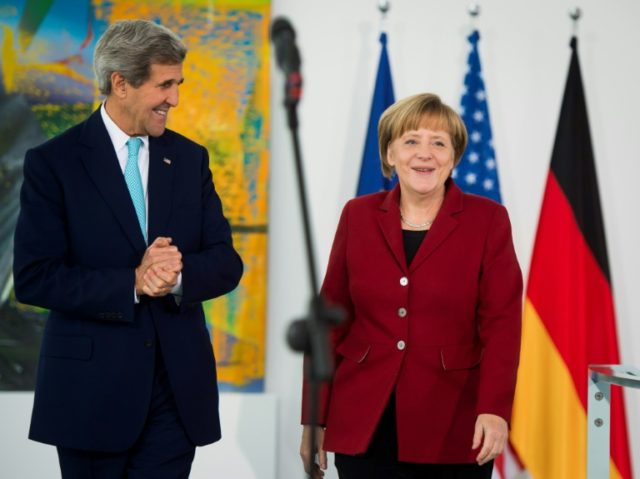 Outgoing US Secretary of State John Kerry (L) called German leader Angela Merkel "courageous"