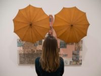 A woman looks at an art work entitled 'Untitled (Spread), 1983' by US artist Robert Rauschenberg during a press preview at the Tate Modern in London on November 29, 2016
