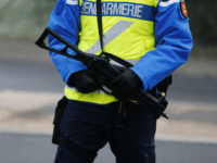 A French gendarme armed with a Heckler and Koch UMP stands guard during a road traffic control in Martainville-Epreville, Normandy, northwestern France, on December 30, 2016.