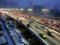 Cars drive along a bridge after snowfall in Urumqi, Xinjiang Autonomous region, in this November 28, 2014 file photo. REUTERS/Stringer