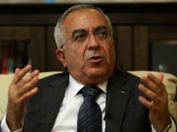 FILE - In this June 28, 2011 file photo, Palestinian Prime Minister Salam Fayyad speaks during an interview with The Associated Press in the West Bank city of Ramallah. Palestinian officials said Thursday, April 11, 2013, that Fayyad offered his resignation to President Mahmoud Abbas as part of an increasingly bitter conflict over authority. (AP Photo/Majdi Mohammed, File)