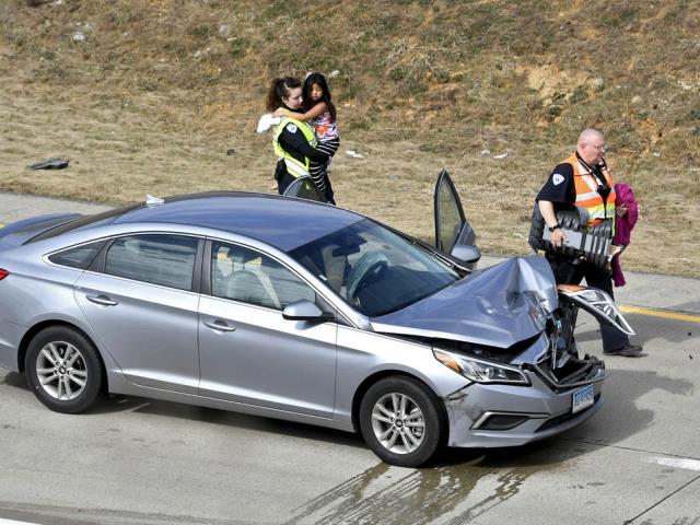 PA State Police troopers rescue Alyn Hernandez after her father crashed his car during a high-speed chase. (Photo: Abby Drey/Centre Daily Times via AP)