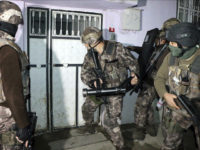 Turkish anti-terrorism police break a door during an operation to arrest people over alleged links to the Islamic State group, in Adiyaman, southeastern Turkey, early Sunday, Feb. 5, 2017. Turkey's state-run agency says anti-terrorism police have detained more than 400 people in simultaneous police operations that spanned several cities, including Istanbul and Gaziantep near the border with Syria, according to the report. (Mahir Alan/Dha-Depo Photos via AP)