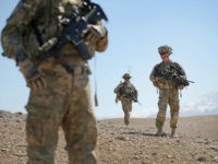 PUL-E ALAM, AFGHANISTAN - MARCH 30: SPC Jack Birge (L) from Lavaca, Arkansas, PFC Marvin Rodriguez (C) from Reisterstown, Maryland and SGT Douglas Carroll from Alma, Georgia with the U.S. Army's 2nd Battalion 87th Infantry Regiment, 3rd Brigade Combat Team, 10th Mountain Division patrol across barren foothills outside of Forward Operating Base (FOB) Shank looking for positions the enemy has used to send rockets onto the FOB on March 30, 2014 near Pul-e Alam, Afghanistan. The primary mission of soldiers with the 10th Mountain Division stationed at FOB Shank is to advise and assist Afghan National Security Forces in the region. Security is at a heightened state throughout Afghanistan as the nation prepares for the April 5th presidential election. (Photo by Scott Olson/Getty Images)