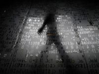 An employee walks past a glass panel at the Moscow headquarters of Kaspersky Lab, whose top investigator was among those detained