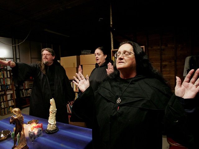 HOOPESTON, IL - OCTOBER 25:  Wicca religion practitioners Rev. Don Lewis (L), Rev. Krystal High-Correll (C), and Rev. Virgina Powell HPS, participate in a Wiccan Lunar ritual in the temple at the Witch School October 25, 2006 in Hoopeston, Illinois. Wicca is a neo-Pagan religion which uses magic and nature in its teachings. The school, which opened in 2003, offers courses in Wicca theology, hosts seminars and Wiccan rituals at the campus.  (Photo by Scott Olson/Getty Images)