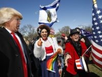 Gays for Trump rally with Joy Villa (Supporters of President Donald Trump, from left, comedian Dustin Gold from Nashville Tenn., singer Joy Villa and fashion designer Andre Soriano, cheer during a rally organized by the North Carolina-based group Gays for Trump, at the National Mall near the Washington Monument in Washington, Saturday, March 4, 2017. The speakers at the rally talked about immigration, gay rights, and several other issues and later marched from the National Mall to the White House. (AP Photo/Manuel Balce Ceneta / Associated Press)