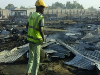 Residents of the Muna camp, near Maiduguri, gather near the site of an explosion on March 22, 2017. At least four suicide bomb blasts rocked a camp for migrants fleeing Boko Haram insurgents in restive northeastern Nigeria, killing at least three people and wounding 20, officials said. The blasts triggered fires which burned down tents in the vast Muna camp on the outskirts of the city of Maiduguri. (Photo by next24online/NurPhoto via Getty Images)