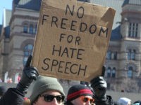 Pro-Muslim protestor carrying a sign saying 'No Freedom for Hate Speech' as opposing groups of protesters clashed over the M-103 motion to fight Islamophobia during pro-Muslim and anti-Muslim demonstrations in downtown Toronto, Ontario, Canada, on March 04, 2017. Canadians across the country staged similar protests against Islam, Muslims, Sharia Law and M-103. These protests were met by counter protests by those supporting Muslims and in favour of M-103. M-103 is a private members motion put forth by Liberal MP Iqra Khalid that asks the government to 'recognize the need to quell the increasing public climate of hate and fear' and condemn Islamophobia, as well as all other kinds of 'systemic racism and religious discrimination.' (Photo by Creative Touch Imaging Ltd./NurPhoto via Getty Images)