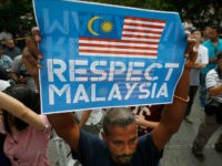 A members of the UMNO (United Malays National Organization) Youth holds up a placard as they gather to protest against the killing of Kim Jong Nam outside North Korean Embassy in Kuala Lumpur, Malaysia, Thursday, Feb. 23, 2017. North Korea denied Thursday that its agents masterminded the assassination of the half brother of leader Kim Jong Un, saying a Malaysian investigation into the death of one of its nationals is full of "holes and contradictions." (AP Photo/Vincent Thian)