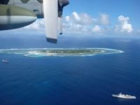 An aerial view shows a Taiwan Coast Guard vessel preparing for a search-and-rescue exercise off Taiping island, in the South China Sea , Tuesday, Nov. 29, 2016, as part of efforts to cement its claim to a key island in the strategically vital waterbody. Eight vessels and three aircraft took part in Tuesday's drill, which simulated a fire aboard a cargo ship that forced crew members to seek safety on Taiping in the Spratly island group. (AP Photo/Johnson Lai)