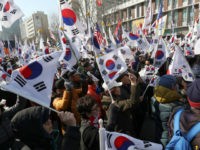 Pro- President Park Guen-Hye hold the national flag near the South Korea's Constitutional Court in Seoul, South Korea on March 10, 2017, after the impeachment of President Park Geun Hye was upheld by the court vote. According to the local police, two people were killed in the protest. Presidential election will be held in 60 days. ( The Yomiuri Shimbun via AP Images )