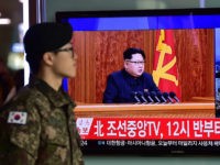 A South Korean soldier walks past a television screen showing a broadcast of North Korean leader Kim Jong-Un's New Year speech, at a railroad station in Seoul on January 1, 2016. North Korean leader Kim Jong-Un said raising living standards was his number one priority in an annual New Year's address on January 1 that avoided any explicit reference to the country's nuclear weapons programme. AFP PHOTO / JUNG YEON-JE / AFP / JUNG YEON-JE (Photo credit should read JUNG YEON-JE/AFP/Getty Images)