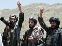 FILE - In this May 27, 2016 file photo, Taliban fighters react to a speech by their senior leader in the Shindand district of Herat province, Afghanistan. Two senior Taliban figures said that Pakistan has issued a stark warning to the militant group, apparently surprised over being excluded from the insurgents' secret talks with the Afghan government. (AP Photos/Allauddin Khan, File)