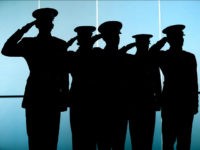 BOSTON, MA - NOVEMBER 13: Marines standing near the glass doors of the Convention Center salute during the National Anthem at the Boston Convention and Exposition Center in Boston on Nov. 13, 2015. A 240th Birthday of the United States Marine Corps luncheon was held, where Marine Corps General Joseph Dunford, Chairman of the Joint Chiefs of Staff was in attendance. (Photo by John Tlumacki/The Boston Globe via Getty Images)